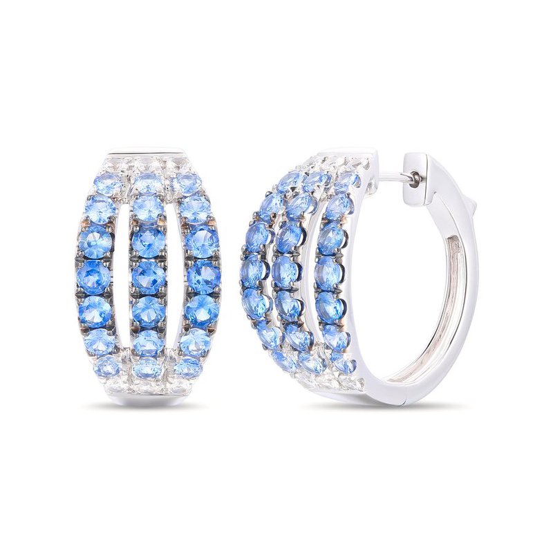 Pair of hoop earrings with blue gradient to clear gemstones set in white gold on a white background