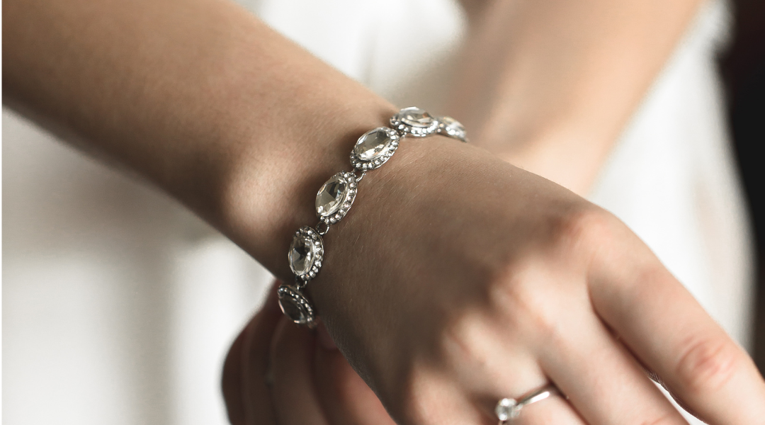 beautiful bracelets with gemstones on what appears to be a bride's wrist, close cropped image