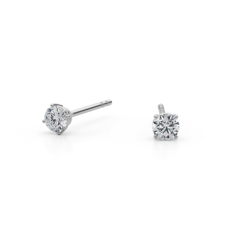 Two diamond stud earrings on a white background