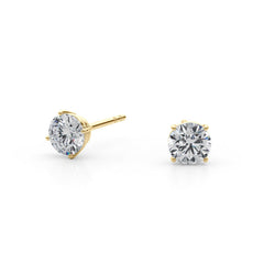 Pair of yellow gold diamond stud earrings on a white background