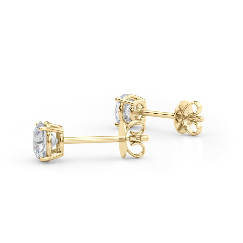 Gold earrings with diamond studs on a white background