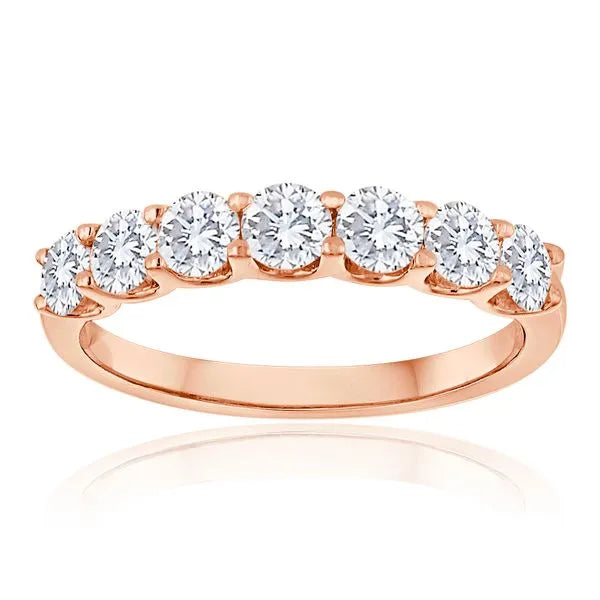 This gold 14K Rose' Gold rose wedding band features a wedding band style with a wedding band setting. The design is accented with diamonds totaling about 0.1 carats.