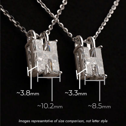 Two single diamond pendants on a chain with size measurements against a black background, one is labeled 10.2mm wide and 3.8mm deep, the other is 8.5mm wide and 3.3mm deep.