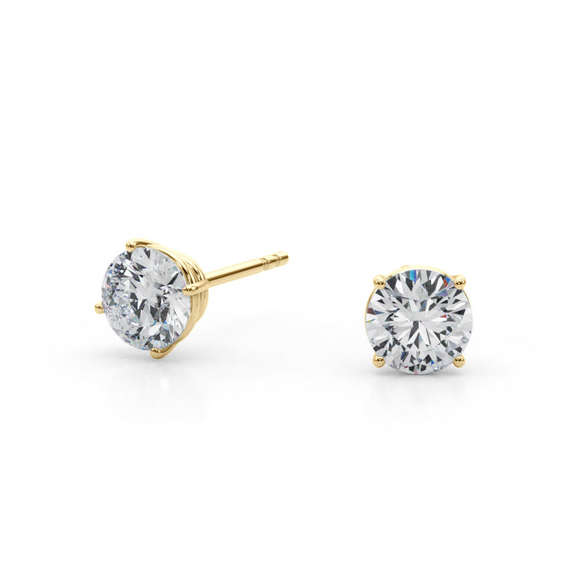 Gold stud earrings with clear diamonds on a white background