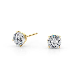 Gold stud earrings with clear diamonds on a white background
