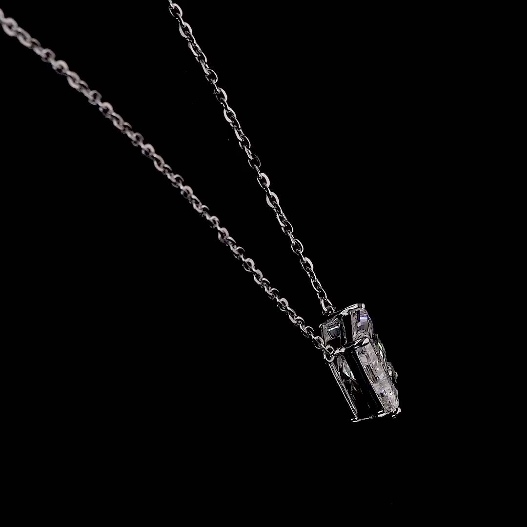 White gold necklace with an "E" shaped diamond letter pendant rotating from various angles over a dark background