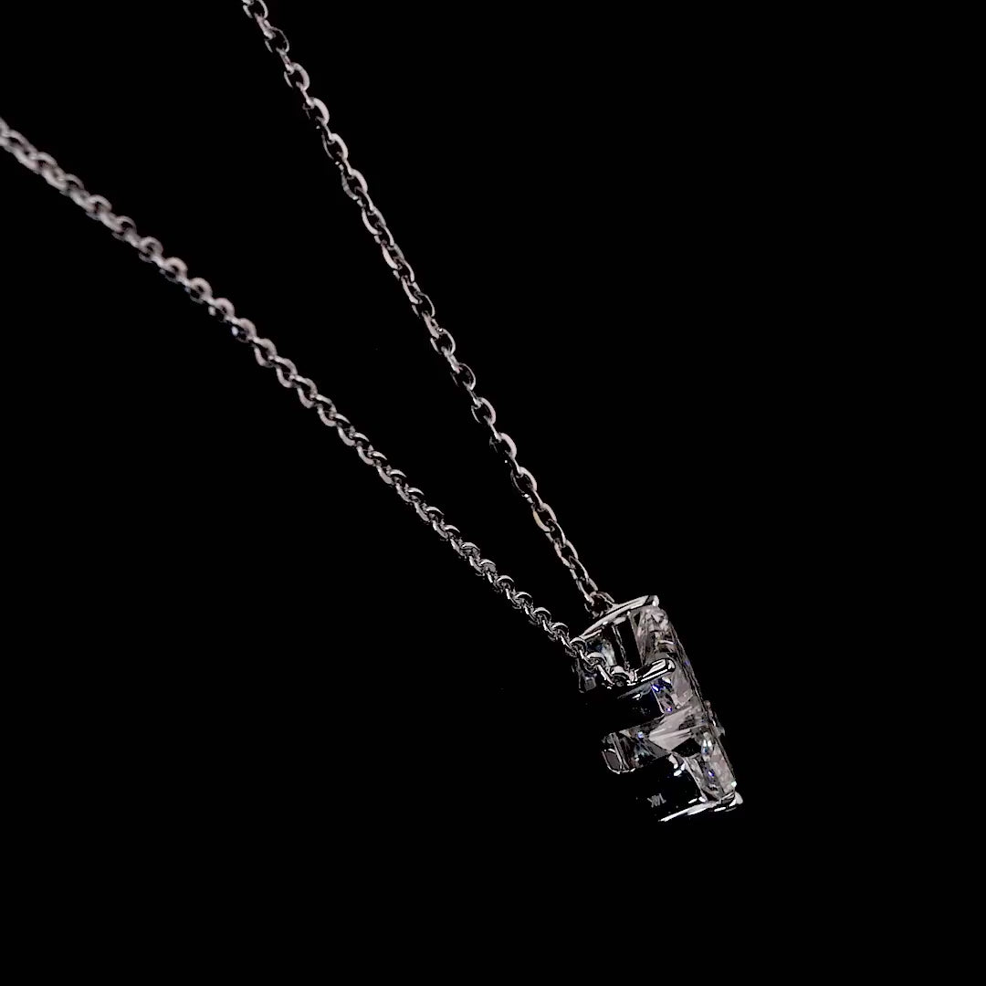 White gold necklace with a "Z" shaped diamond letter pendant rotating from various angles over a dark background