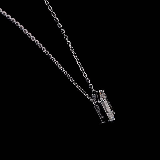 White gold necklace with a "G" shaped diamond letter pendant rotating from various angles over a dark background