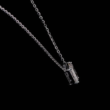 White gold necklace with a "G" shaped diamond letter pendant rotating from various angles over a dark background