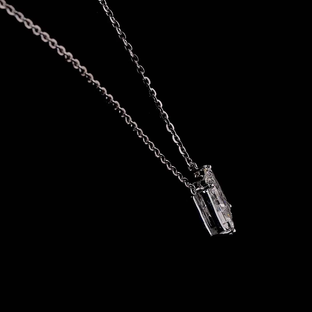 White gold necklace with an "M" shaped diamond letter pendant rotating from various angles over a dark background