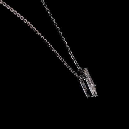 White gold necklace with an "M" shaped diamond letter pendant rotating from various angles over a dark background