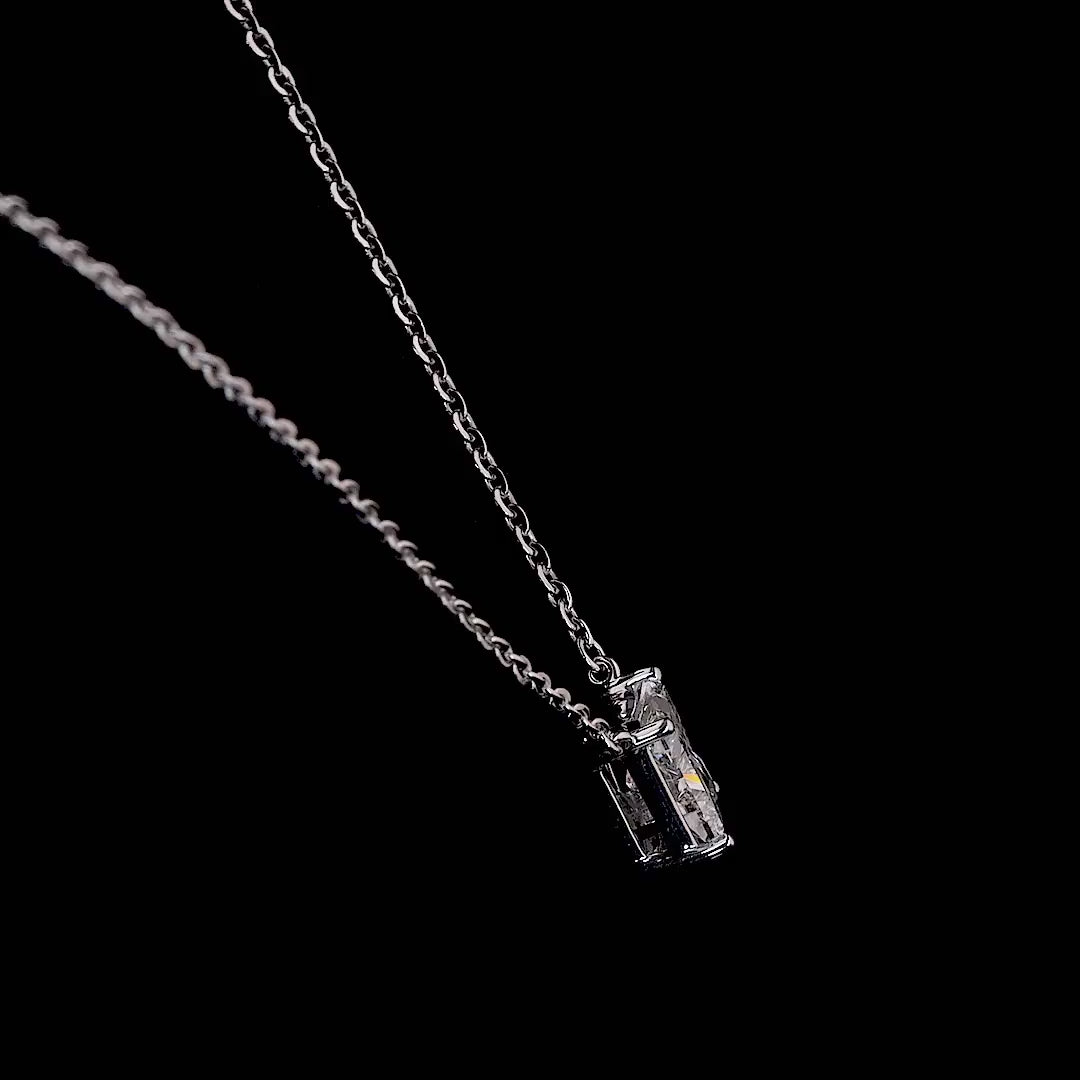 White gold necklace with a "K" shaped diamond letter pendant rotating from various angles over a dark background