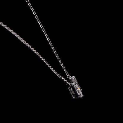 White gold necklace with a "K" shaped diamond letter pendant rotating from various angles over a dark background