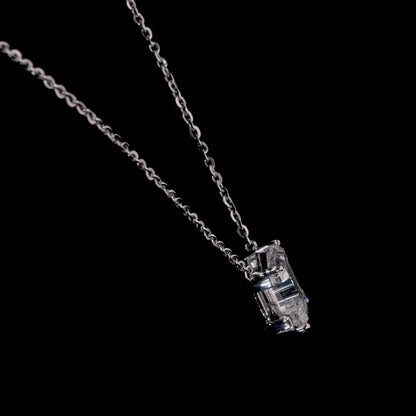 White gold necklace with an "I" shaped diamond letter pendant rotating from various angles over a dark background