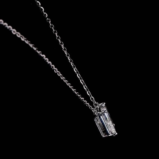 White gold necklace with an "R" shaped diamond letter pendant rotating from various angles over a dark background