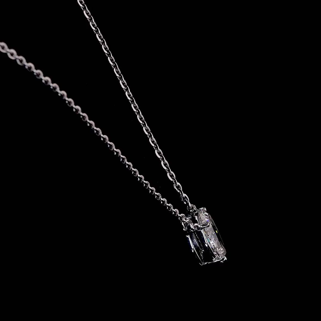 Video of a white gold necklace with a "O" shaped diamond letter pendant rotating from various angles over a dark background