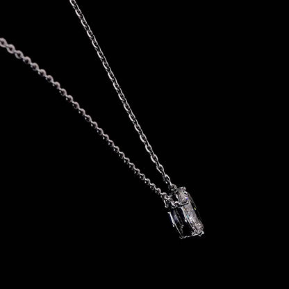 Video of a white gold necklace with a "O" shaped diamond letter pendant rotating from various angles over a dark background