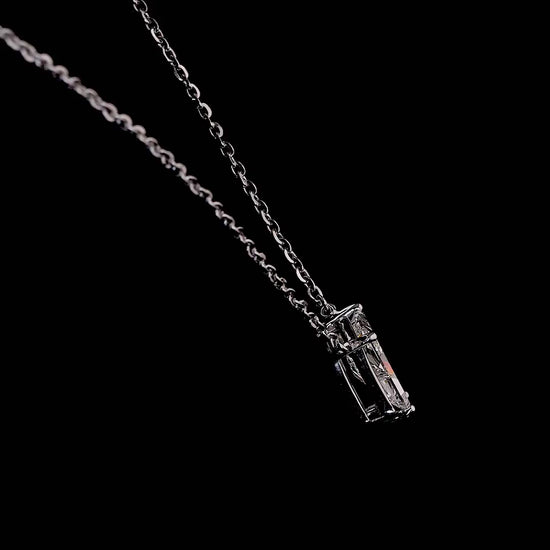 White gold necklace with a "P" shaped diamond letter pendant rotating from various angles over a dark background