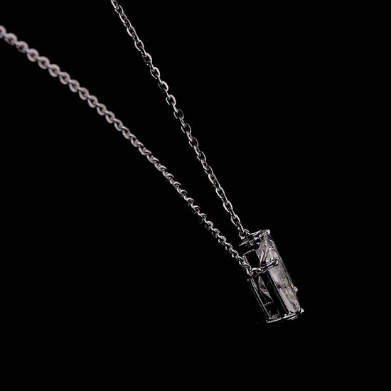 White gold necklace with a "W" shaped diamond letter pendant rotating from various angles over a dark background