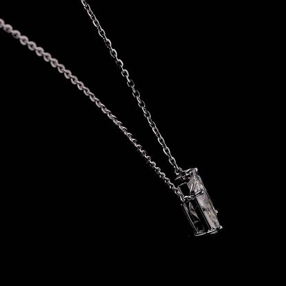 White gold necklace with a "W" shaped diamond letter pendant rotating from various angles over a dark background