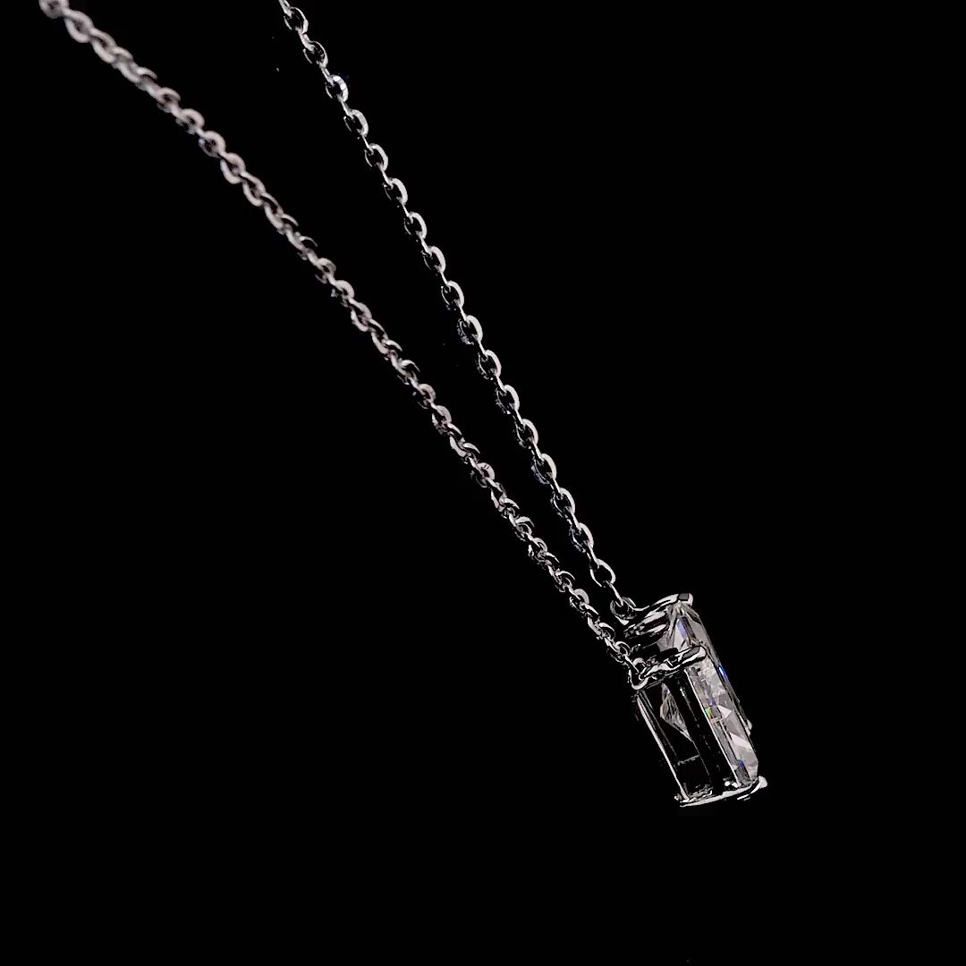 White gold necklace with an "N" shaped diamond letter pendant rotating from various angles over a dark background