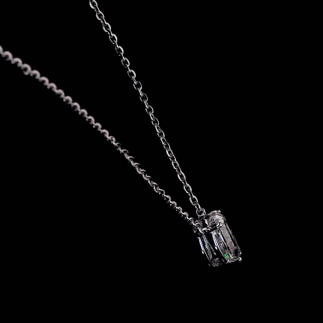 Video of a white gold necklace with a "Q" shaped diamond letter pendant rotating from various angles over a dark background