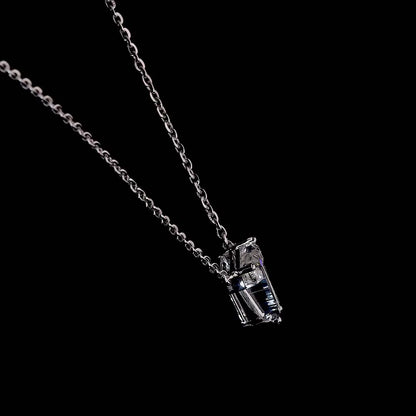 White gold necklace with a "T" shaped diamond letter pendant rotating from various angles over a dark background