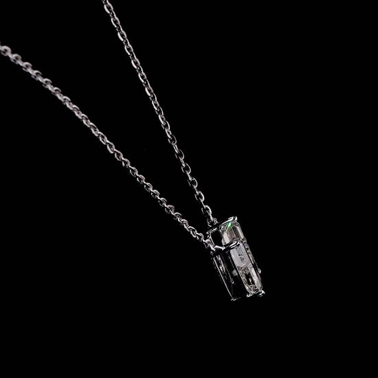 White gold necklace with a "U" shaped diamond letter pendant rotating from various angles over a dark background