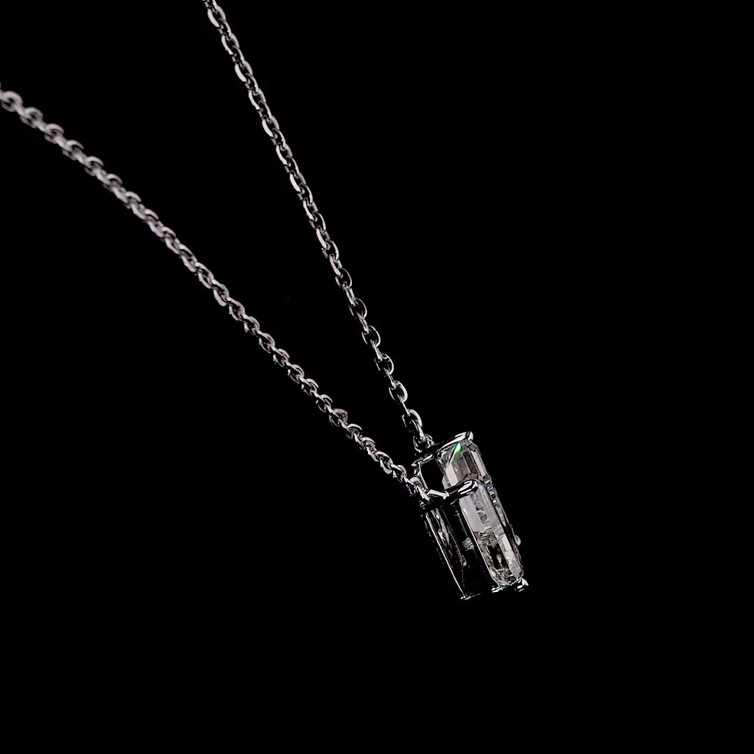 White gold necklace with a "U" shaped diamond letter pendant rotating from various angles over a dark background