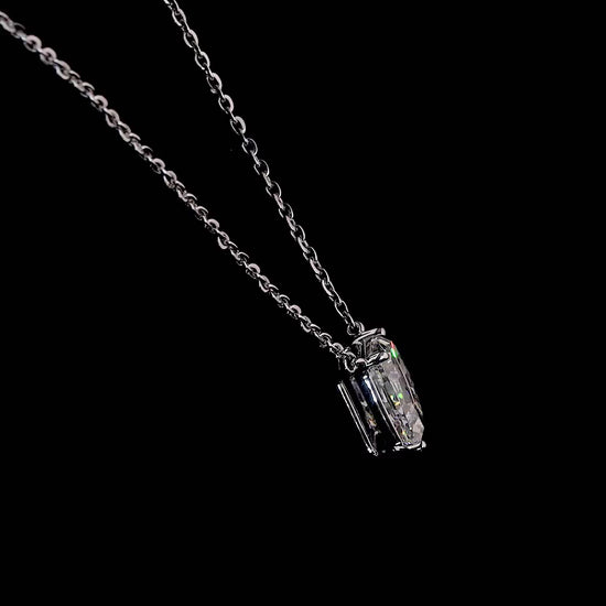 White gold necklace with a "D" shaped diamond letter pendant rotating from various angles over a dark background