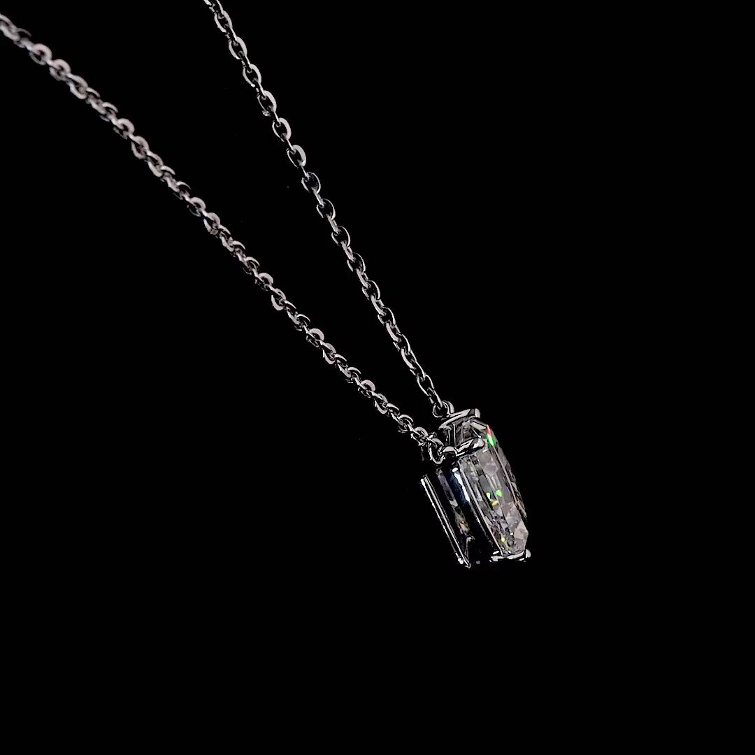 White gold necklace with a "D" shaped diamond letter pendant rotating from various angles over a dark background