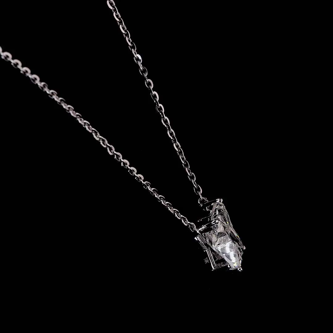 White gold necklace with an "X" shaped diamond letter pendant rotating from various angles over a dark background