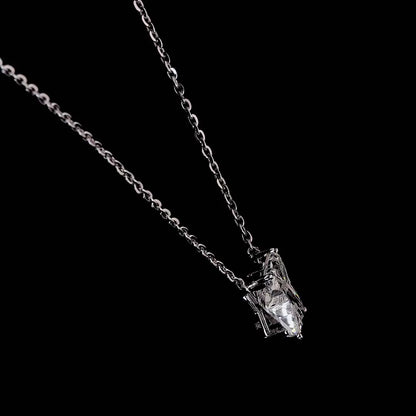 White gold necklace with an "X" shaped diamond letter pendant rotating from various angles over a dark background