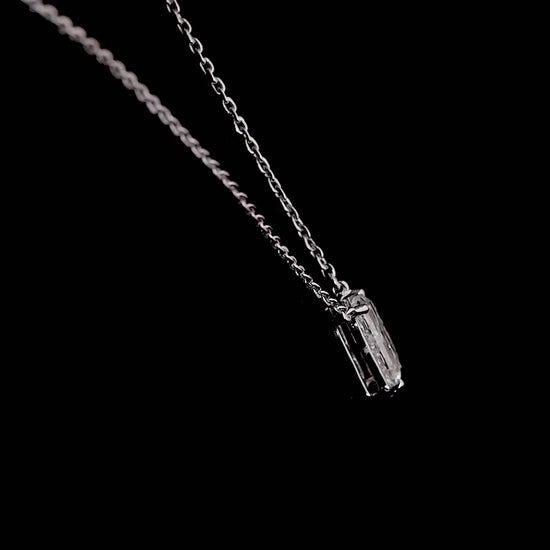 White gold necklace with a "B" shaped diamond letter pendant rotating from various angles over a dark background