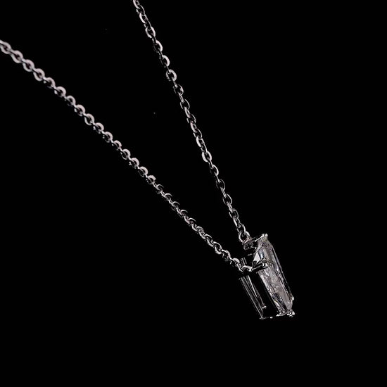 White gold necklace with a "V" shaped diamond letter pendant rotating from various angles over a dark background