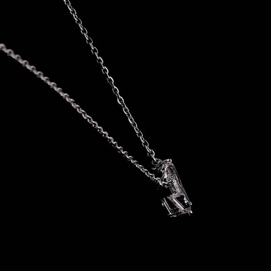 White gold necklace with a "Y" shaped diamond letter pendant rotating from various angles over a dark background